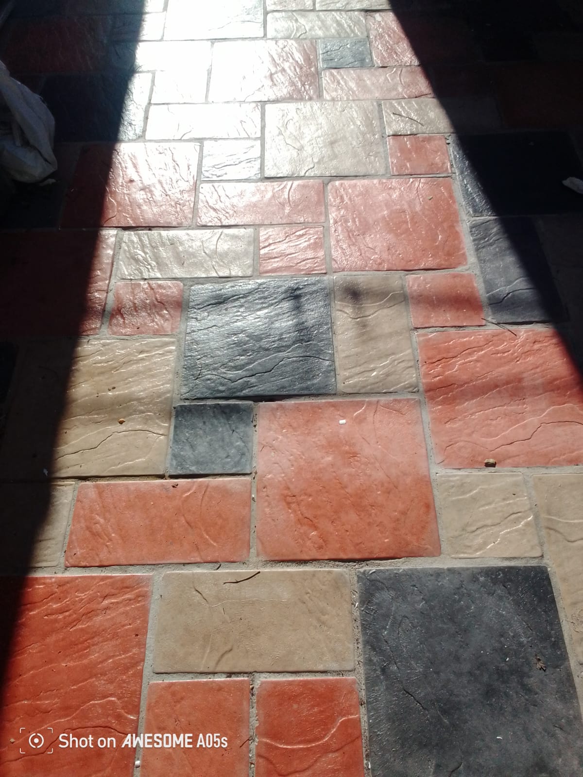 Multi-colour stamped concrete paving in terracotta, charcoal and stone — Cape Town home
