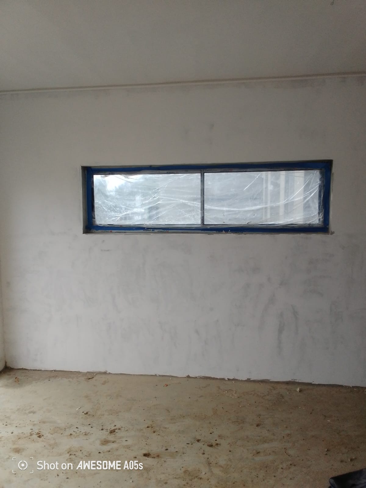 Skimmed and painted interior wall with door and open electrical box