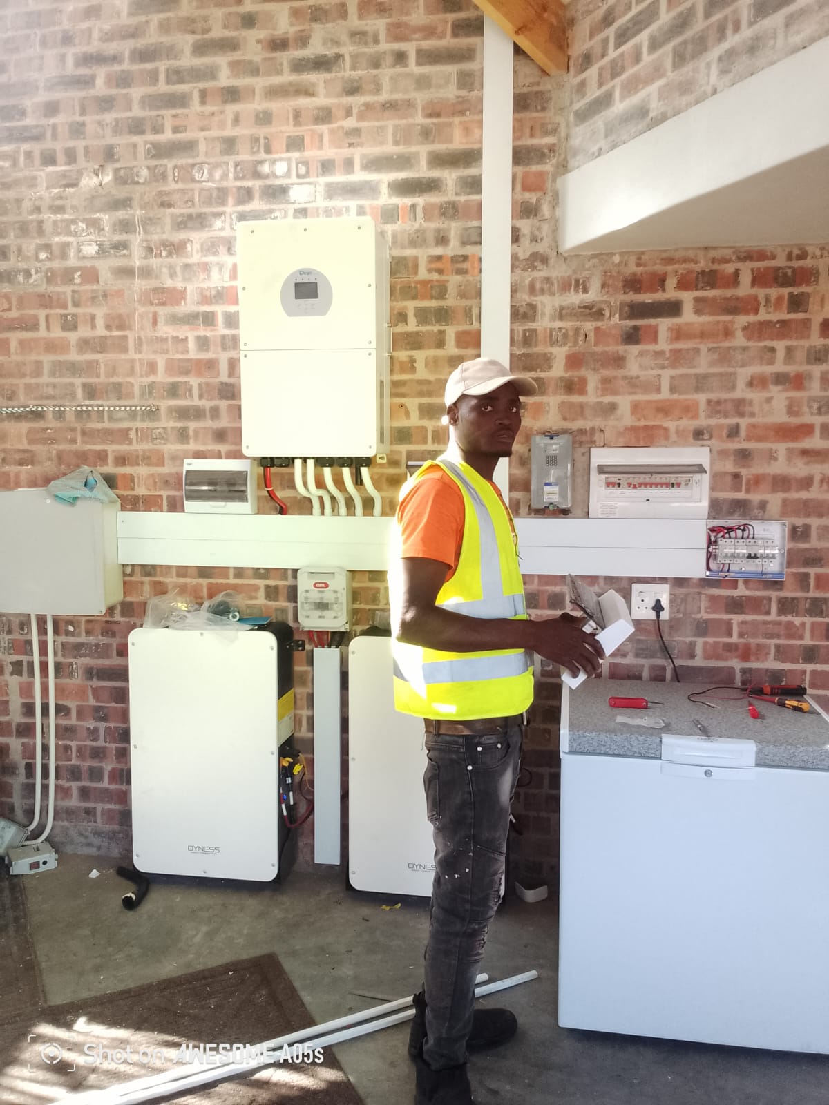Solar PV array on a tile roof with the installer on site