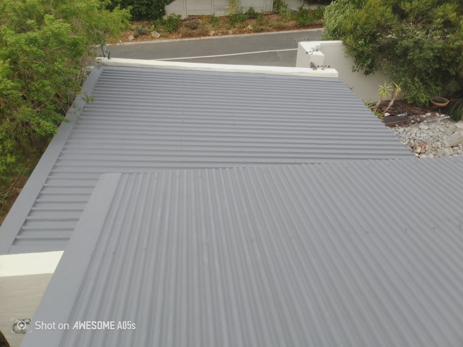 New corrugated metal roof sheeting on multiple gables