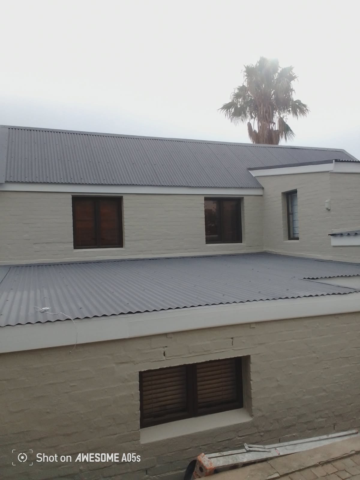 Flat-pitch corrugated metal roof, freshly installed